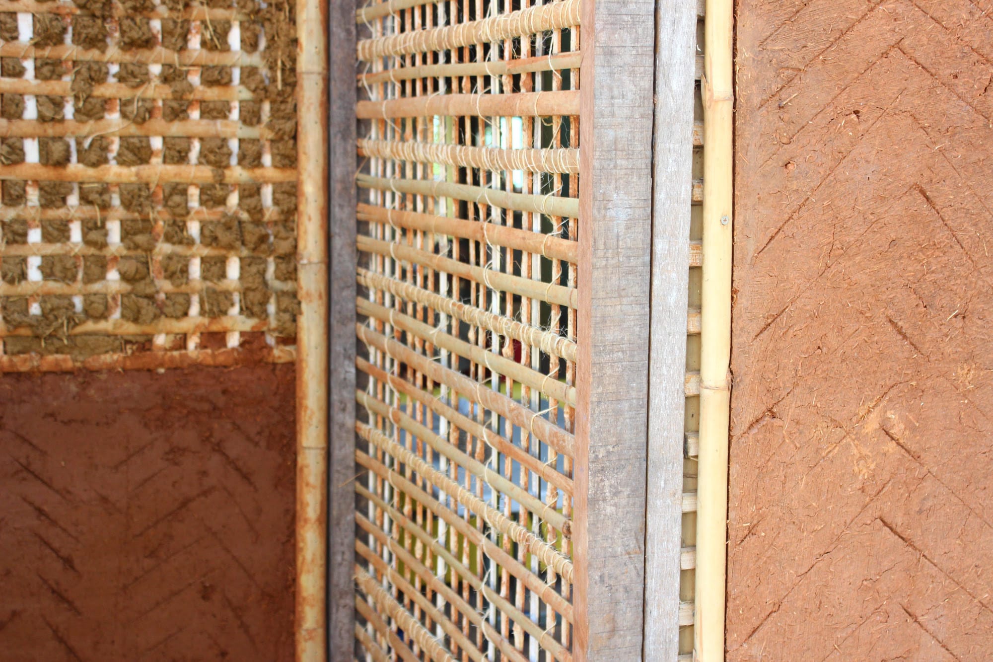 Close detail of a bamboo lattice wall packed with earthen infill at Daruma