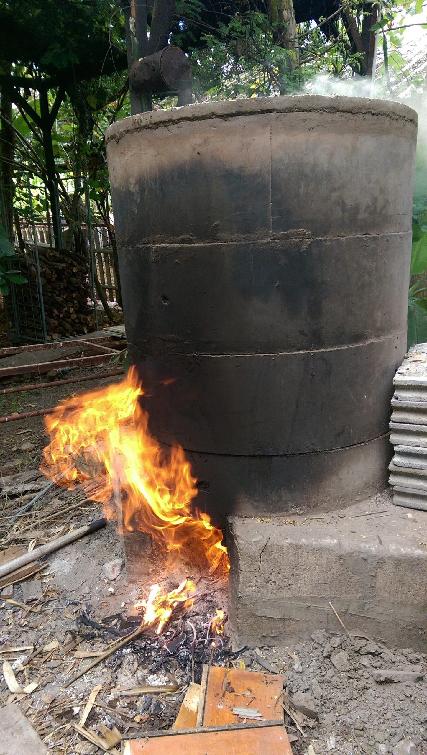 The round kiln chimney at Daruma with smoke rising from its metal pipe cap