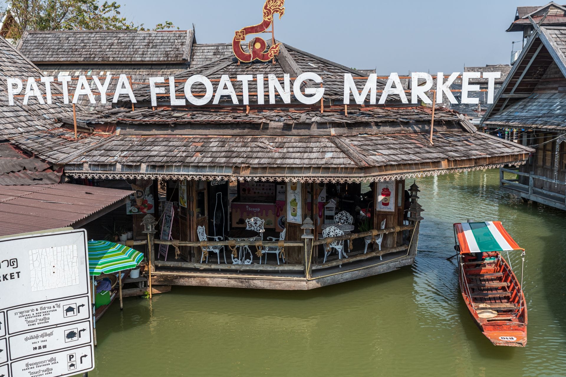 Wooden pavilions and a long-tail boat at the Pattaya Floating Market in Chonburi